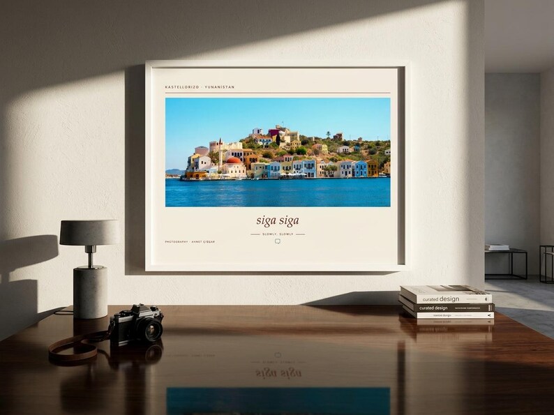 May include: A framed horizontal wall art print featuring a vibrant photograph of the Greek island of Kastellorizo with colorful buildings along the water. The print includes the text Kastellorizo, Yunanistan, siga siga, and photography by Ahmet Alkan.