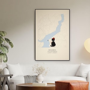 May include: A framed wall art print featuring a map of Istanbul with the Bosphorus in light blue. A black cat wearing a red fez sits by the water, holding a small glass of tea. Text reads: ISTANBUL, Tea by the Bosphorus, 41.0082&deg; N, 28.9784&deg; E.