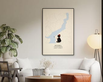 May include: A framed wall art print featuring a map of Istanbul with the Bosphorus in light blue. A black cat wearing a red fez sits by the water, holding a small glass of tea. Text reads: ISTANBUL, Tea by the Bosphorus, 41.0082° N, 28.9784° E.