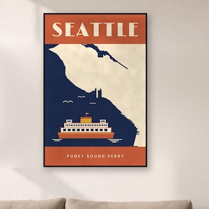 May include: A framed vertical wall art print featuring a stylized map of Seattle with a dark blue water section and a cream land section. An orange ferry boat is centered at the bottom with the text SEATTLE at the top and PUGET SOUND FERRY below.