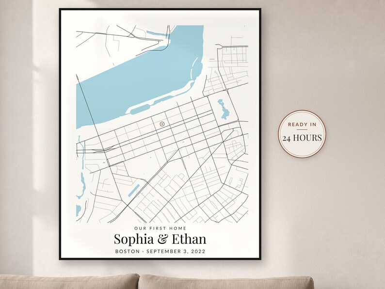 May include: A framed map print featuring a light blue body of water and black street lines. The text reads: OUR FIRST HOME, Sophia & Ethan, BOSTON - SEPTEMBER 3, 2022. A circular badge on the right side displays the text: READY IN 24 HOURS.