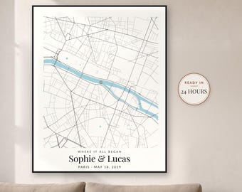 May include: A framed map print of Paris featuring black street lines and a light blue river. The text reads WHERE IT ALL BEGAN, Sophie & Lucas, PARIS, MAY 18, 2019. A circular badge on the right side displays the text READY IN 24 HOURS.