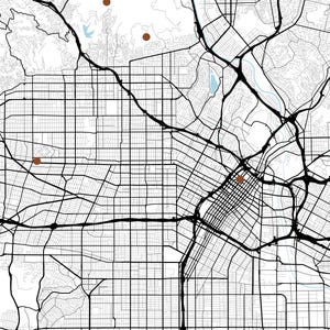 May include: A black and white street map featuring a grid of roads, highways, and topographical lines. Four solid brown circular markers are placed at specific locations across the urban layout, highlighting points of interest on the map.