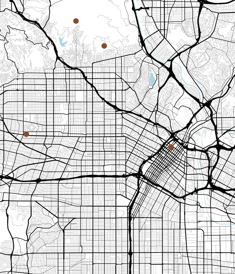 May include: A black and white street map featuring a grid of roads, highways, and topographical lines. Four solid brown circular markers are placed at specific locations across the urban layout, highlighting points of interest on the map.