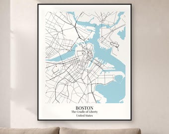 May include: A framed wall art print featuring a stylized map of Boston, Massachusetts. The map displays black street lines against a white background with light blue water areas. Text at the bottom reads BOSTON, The Cradle of Liberty, United States.