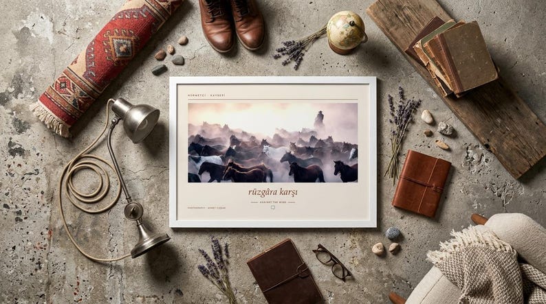 May include: A rectangular white-framed wall art print featuring a photograph of a herd of horses running through dust. The print includes the text "r&uuml;zg&acirc;ra karşı" centred below the image, with additional small text at the top and bottom corners.