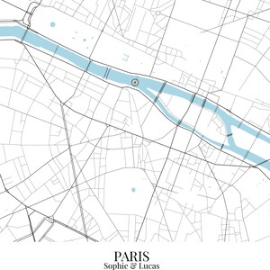 May include: A map print of Paris featuring black street lines on a white background with a light blue river. A circular marker highlights a specific location. Text at the bottom reads: PARIS, Sophie & Lucas, Where It All Began, May 18, 2019.
