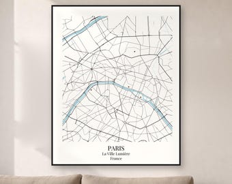 May include: A framed wall art print featuring a minimalist map of Paris, France. The map displays black street lines on a white background with a light blue river winding through the center and small red dots marking specific locations.
