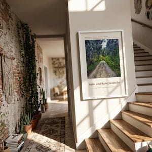 May include: A rectangular white-framed wall art print featuring a photograph of a dirt path winding through a dense green forest. The print includes the Turkish text "Yeşilin i&ccedil;inde kaybol, kendini bul" and English text "Lose yourself in the forest, find yourself."