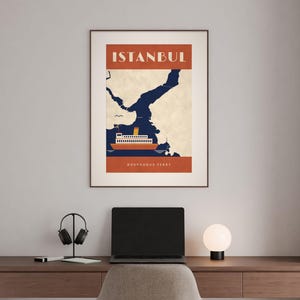 May include: A framed wall art print featuring a stylized graphic of a Bosphorus ferry on dark blue water against a cream map background. The top section has the text ISTANBUL in white, and the bottom section reads BOSPHORUS FERRY in white.