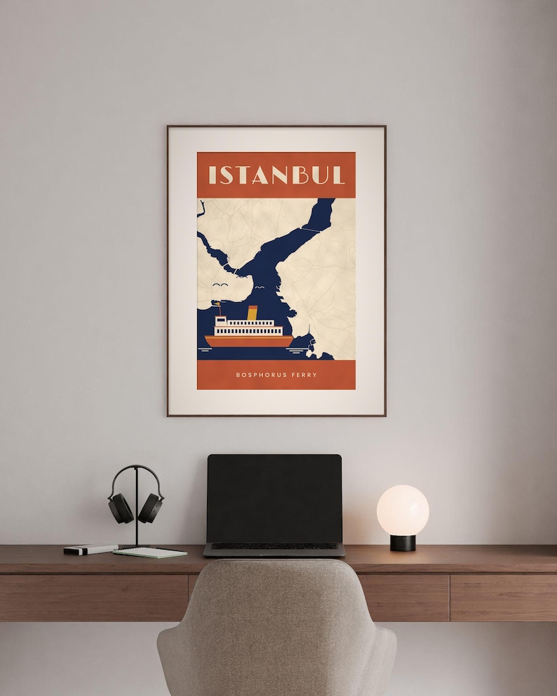 May include: A framed wall art print featuring a stylized graphic of a Bosphorus ferry on dark blue water against a cream map background. The top section has the text ISTANBUL in white, and the bottom section reads BOSPHORUS FERRY in white.