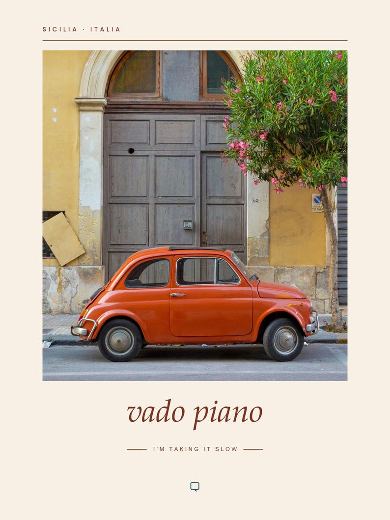 May include: A vintage orange compact car parked in front of a brown wooden door and a yellow building wall. The text "SICILIA ITALIA" appears at the top, while the text "vado piano" and "I'M TAKING IT SLOW" are printed at the bottom.