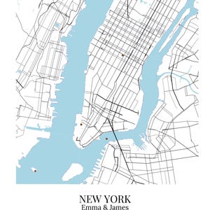 May include: A map print of New York City featuring black street lines on a white background with light blue water areas. Five small brown dots mark specific locations. Text reads: NEW YORK, Emma & James, 40.7128&deg; N 74.0060&deg; W, October 12, 2024.