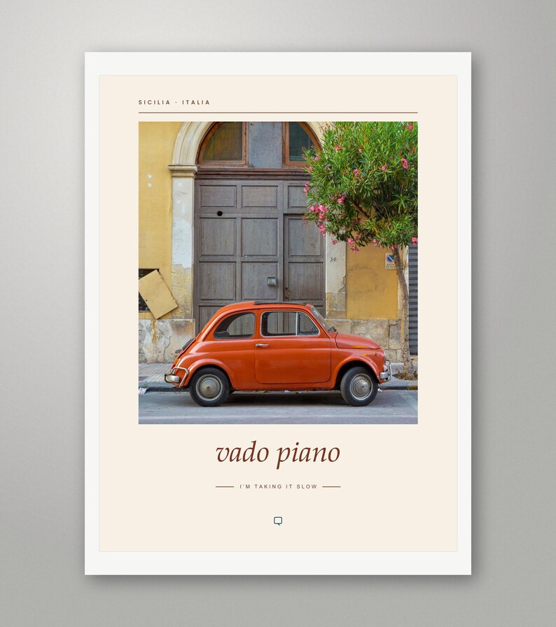 May include: A framed wall art print featuring a vintage orange car parked in front of a brown wooden door and a yellow building. The text reads SICILIA ITALIA, vado piano, and I'M TAKING IT SLOW, with a small speech bubble icon at the bottom.