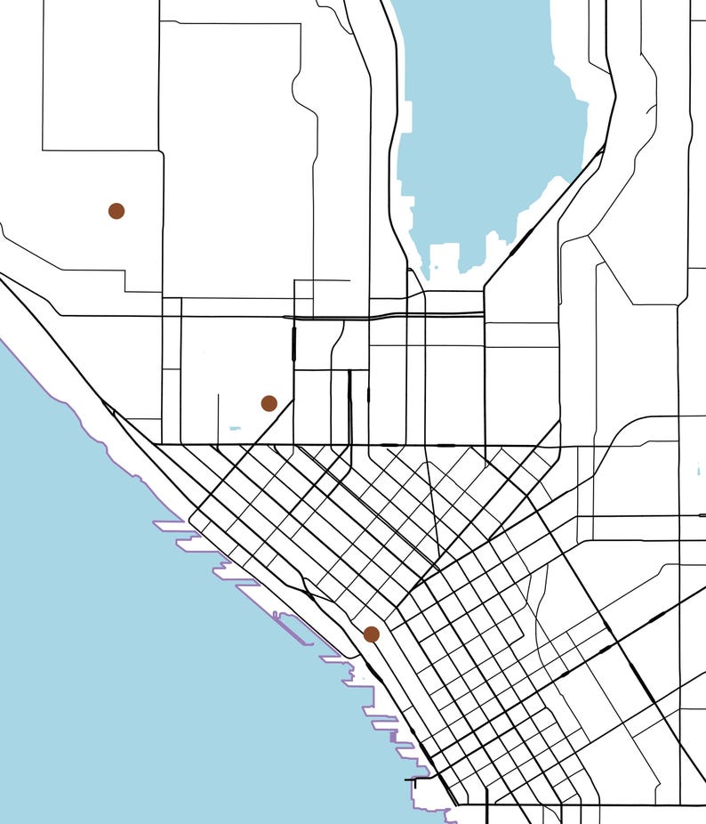May include: A minimalist map illustration featuring black street grid lines on a white background, with a light blue body of water along the left and top edges. Three small, solid brown circular markers are placed at specific locations.