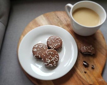 Chocolate covered sandwich cookie with sprinkles