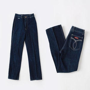 May include: Two pairs of blue denim jeans. One pair has a high waist and straight legs. The other pair has a lower waist and a more relaxed fit.