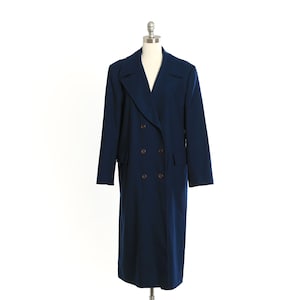 May include: A navy blue double-breasted coat with a classic design. The coat features a notched collar, two rows of brown buttons, and a long, tailored silhouette. The coat is displayed on a mannequin against a white background.