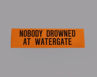 Vintage 1970s Watergate "Nobody drowned at watergate" neon orange bummer sticker