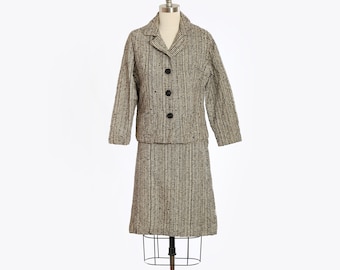 May include: A black and white checkered skirt suit with a fitted jacket and a knee-length skirt.