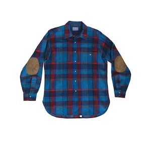 May include: A blue, red, and black plaid flannel shirt with brown elbow patches. The long-sleeved shirt has a button-down front, a chest pocket, and buttoned cuffs. The shirt is laid flat on a white background.