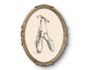 May include: A pair of ballet slippers hanging by their ribbons, depicted in a detailed black and white sketch on a cream background. The artwork is enclosed within an ornate, oval-shaped metallic frame featuring intricate scrollwork and floral carvings.