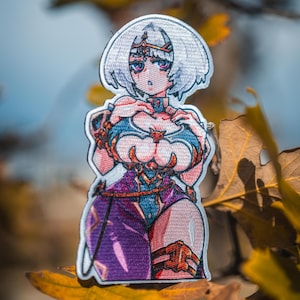 May include: An embroidered patch featuring an anime-style character with short white hair, wearing a blue and purple outfit with gold accents. The character has large eyes and is depicted from the waist up with detailed stitching and vibrant colors.