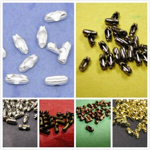 May include: Assortment of metal chain connectors in various finishes, including silver, black, gold, and copper. The connectors are small and have a simple design.