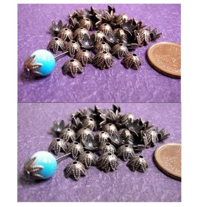 May include: A pile of 30 silver-toned metal bead caps with a starburst design. The caps are approximately 1.2 cm in diameter. A Canadian penny is included for size reference.