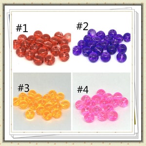 May include: Four groups of colorful, translucent beads with a white, string-like design. The beads are labeled #1, #2, #3, and #4. The beads are red, purple, yellow, and pink.