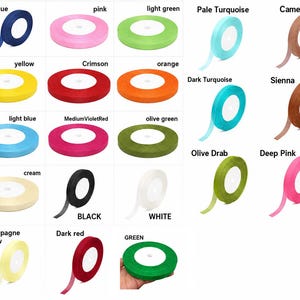 May include: A collection of spools of ribbon in various colors, including dark blue, pink, light green, yellow, crimson, orange, light blue, medium violet red, olive green, cream, black, white, champagne yellow, dark red, and green. Each spool is labeled with its color name.