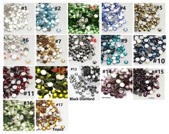 May include: Assortment of 17 different colors of rhinestones, each color is labeled with a number. The colors include clear, light blue, green, dark blue, silver, gold, black, light amethyst, amethyst, red, dark green, topaz, and black diamond.
