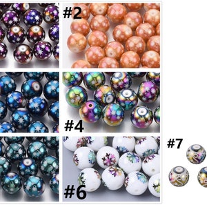 May include: Assortment of 7 different styles of round iridescent glass beads with snowflake designs. The beads are approximately 1 inch in diameter.