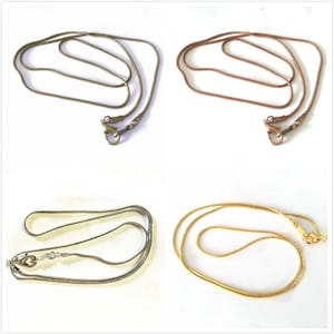 May include: Four snake chain necklaces in different colors: gold, silver, rose gold, and copper. The chains are all the same length and have a lobster clasp.