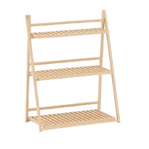 May include: A three-tiered wooden plant stand with a light brown finish. The stand is made of slats and has a ladder-like design.