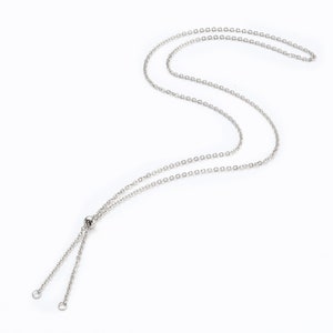 May include: A silver chain necklace with an adjustable length. The chain is made of small, linked circles.