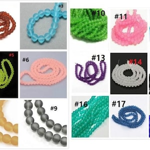 May include: Twenty different strands of glass beads in various colours, including purple, orange, blue, green, pink, and grey. Each strand is labelled with a number from 1 to 20.