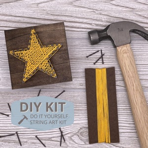 May include: DIY string art kit with a yellow star design on a wooden base. The kit includes a hammer, nails, and string.