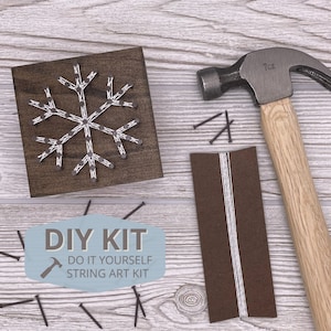 May include: DIY string art kit with a snowflake design. The kit includes a wooden frame, string, nails, and a hammer.