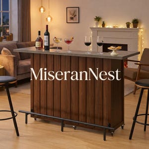 May include: A dark wood bar unit with vertical paneling, a gray countertop, and a black metal footrest. The bar features the text MiseranNest and is set with two wine bottles, two cocktail glasses, two wine glasses, and a small white pedestal dish.