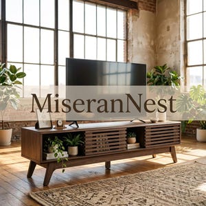 May include: A dark wood television stand with slatted sliding doors, four open storage compartments, and angled legs. The unit holds a flat-screen television, a framed picture, a small clock, and potted plants. The text MiseranNest is visible.
