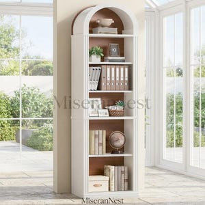 May include: A tall, white, arched bookcase with a dark wood interior back panel. The shelving unit features five levels holding various items including binders, books, a small globe, a decorative bowl, and a potted plant. The structure is freestanding.