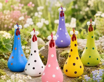 May include: A collection of six teardrop-shaped chicken figurines in blue, white, pink, purple, yellow, and green. Each chicken features a smooth body with contrasting polka dots, a red wattle, and two large, wide-set white eyes.