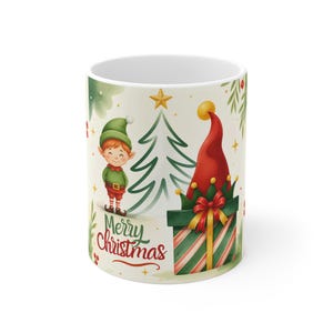 Puede incluir: Una taza de cerámica blanca con una ilustración festiva de un elfo sonriente con traje verde, un árbol de Navidad estilizado y una caja de regalo con un lazo rojo. El texto Merry Christmas está escrito en rojo, rodeado de pequeñas estrellas doradas.