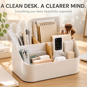 May include: A white plastic desk organizer with light wood dividers, featuring multiple compartments filled with office supplies including scissors, a ruler, notebooks, makeup brushes, a remote control, and small boxes, with the text A CLEAN DESK. A CLEARER MIND.