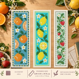 May include: Three rectangular cross-stitch patterns on Aida fabric. The left features oranges and blossoms on blue, the center shows lemons and blossoms on turquoise, and the right displays strawberries and vines on light green. Finished size 1.61–2.33 x 7.78 in.