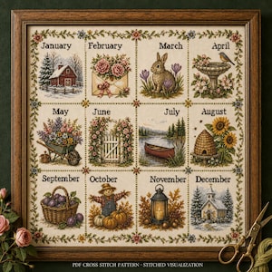 May include: A framed cross-stitch sampler featuring twelve seasonal vignettes labeled by month, including a winter barn, floral envelope, rabbit, birdbath, wheelbarrow, garden gate, canoe, beehive, fruit basket, scarecrow, lantern, and church.