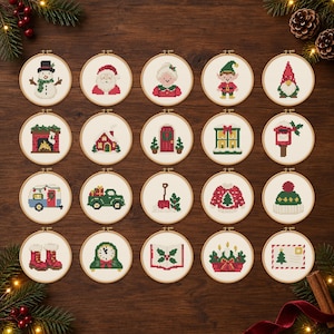 May include: A collection of twenty circular wooden embroidery hoops, each containing a unique Christmas-themed cross-stitch pattern including a snowman, Santa, elf, gnome, fireplace, house, door, window, mailbox, camper, truck, shovel, sweater, hat, boots, clock, book, candles, and letter.