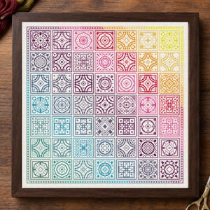 May include: A framed cross-stitch sampler featuring a grid of forty-nine square blocks, each containing a unique geometric pattern. The design displays a vibrant color gradient transitioning from purple and blue to yellow and red.
