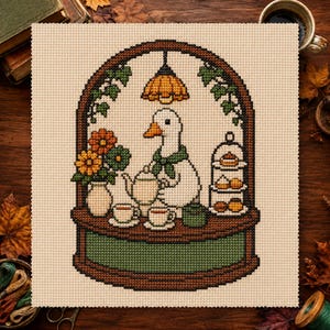 May include: A cross-stitch embroidery on beige fabric featuring a white goose wearing a green scarf, pouring tea from a teapot. The scene includes a vase with orange and green flowers, a tiered dessert stand, and a hanging lamp inside an arch.